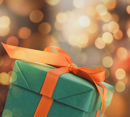 Christmas gift box on blurred background, bokeh effect