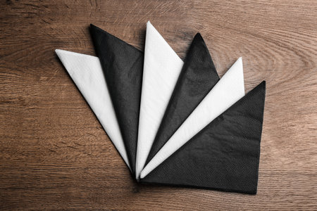 Folded clean paper tissues on wooden table, flat layの写真素材