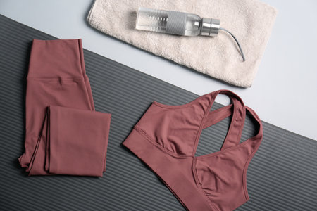 Flat lay composition with yoga equipment on gray background