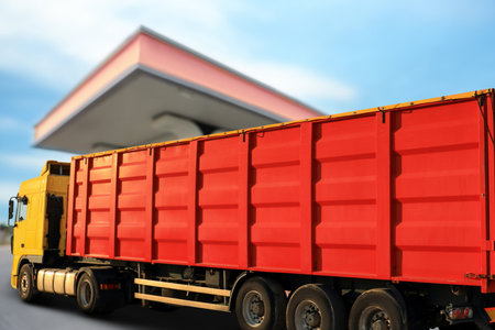 Bright truck driving to modern gas filling station