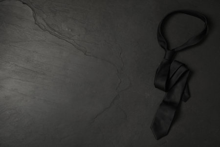 Top view of stylish elegant necktie on dark background, space for text. black friday conceptの写真素材