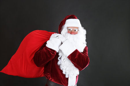 Portrait of Santa Claus with sack on black backgroundの写真素材