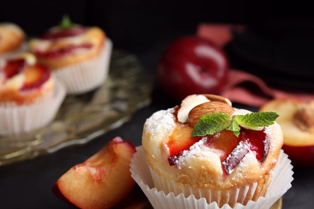Delicious cupcakes with plums on black background, closeupの写真素材