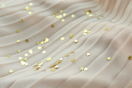 Confetti stars on beige fabric. christmas celebrationの写真素材