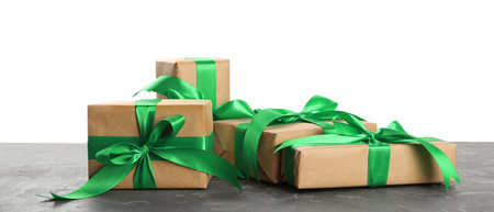 Many Christmas gifts on gray table against white background