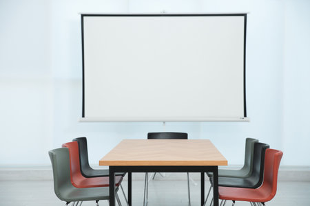 Conference room interior with wooden table and video projection screenの写真素材