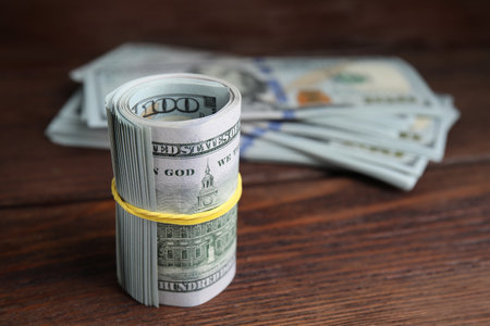 Many dollar banknotes on wooden table, closeup. Space for textの写真素材