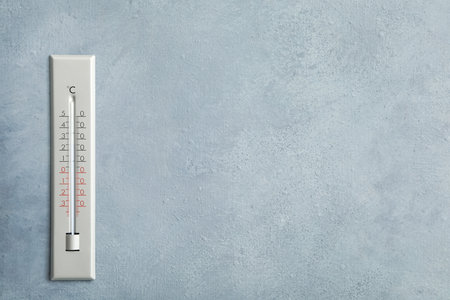 Weather thermometer on gray wall. Space for textの写真素材
