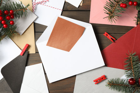 Flat lay composition with blank greeting cards and Christmas decor on wooden table. Space for text