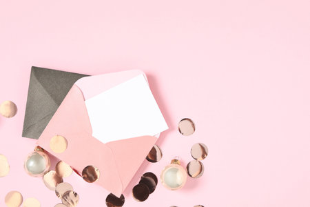 Flat lay composition with blank greeting card and Christmas balls on pink background, space for textの写真素材