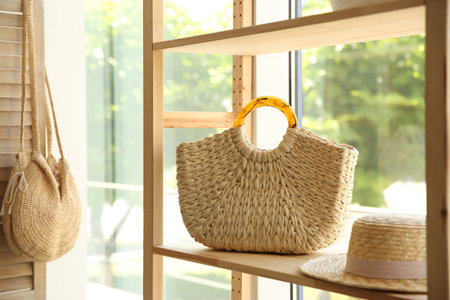 Stylish knitted woman's bag on shelf in boutiqueの写真素材