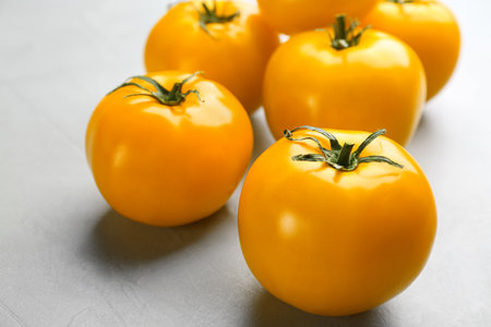 Ripe yellow tomatoes on gray table, closeupの写真素材