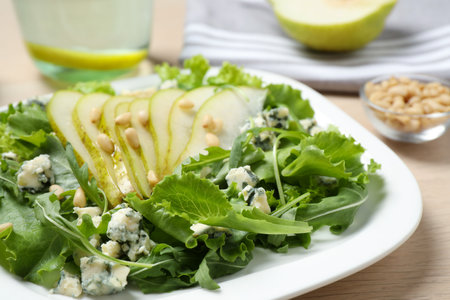 Fresh salad with pear on table, closeupの写真素材