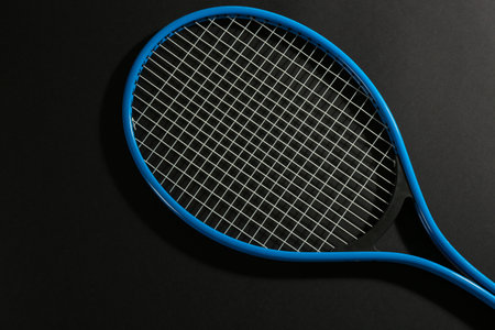 Tennis racket on black background, top view. sports equipmentの写真素材