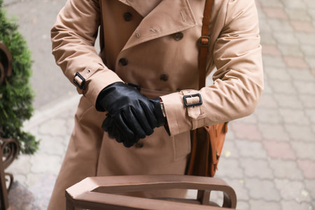 Stylish man wearing black leather gloves outdoors, closeupの写真素材
