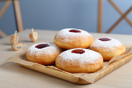 Hanukkah donuts with jelly and sugar powder served on wooden table, closeupの写真素材
