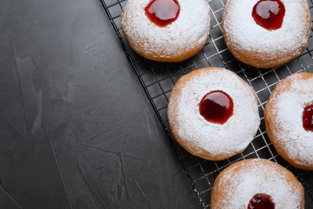 Hanukkah donuts with jelly and sugar powder on gray table, flat lay. Space for textの写真素材