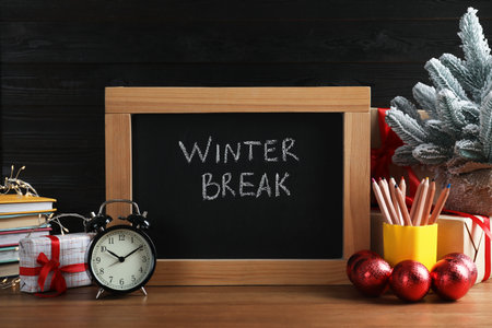Chalkboard with phrase Winter Break, Christmas decor and stationery on wooden table. Holiday conceptの写真素材