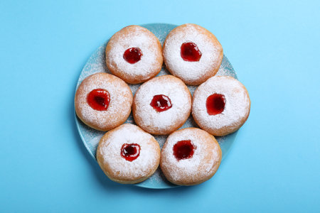 Hanukkah donuts with jelly and sugar powder served on blue background, top viewの写真素材