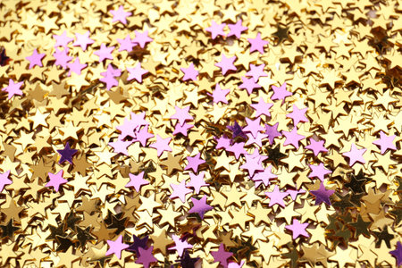 Golden and purple confetti stars as background, closeup. christmas celebrationの写真素材