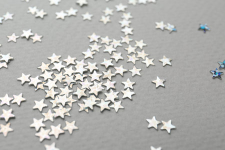 Confetti stars on gray background, closeup. christmas celebration