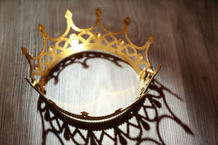 Beautiful golden crown with gems on wooden table. fantasy item