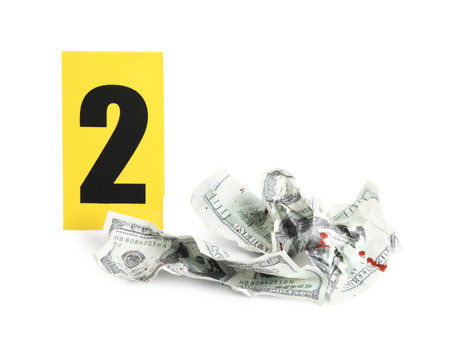 Bloody crumpled dollars and crime scene marker with number two isolated on whiteの写真素材