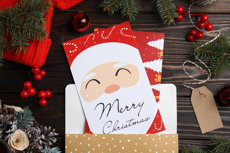 Flat lay composition with Christmas cards on wooden backgroundの写真素材