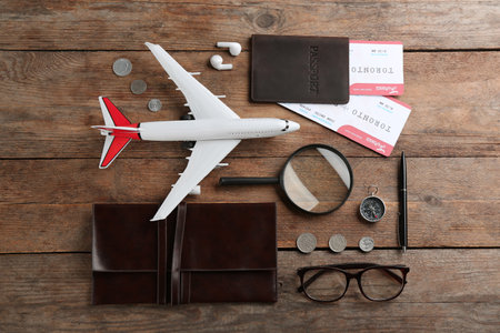 Flat lay composition with toy airplane and travel items on wooden backgroundの写真素材
