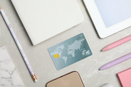 Flat lay composition with credit card and stationery on light gray marble backgroundの写真素材
