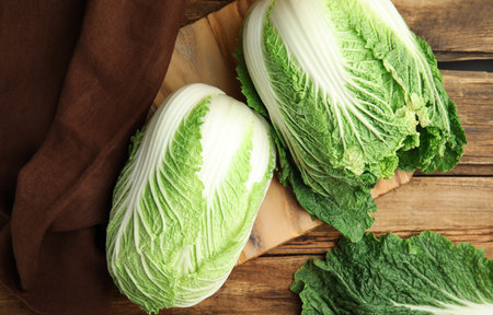 Fresh ripe Chinese cabbages on wooden table, flat layの写真素材