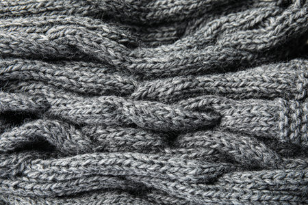 Soft gray knitted plaid as background, closeup