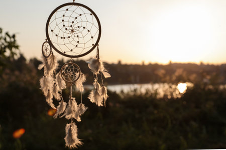 Beautiful handmade dream catcher outdoors. Space for textの写真素材