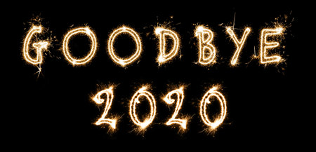 Goodbye 2020. Bright text made of sparkler on black background, banner designの写真素材