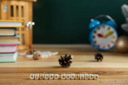 Wooden cubes with phrase Winter Holidays on table. Space for text