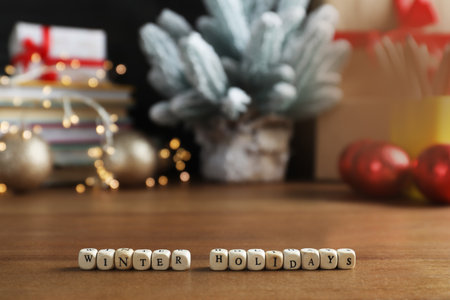 Cubes with phrase Winter Holidays and blurred Christmas decor on background. Space for textの写真素材