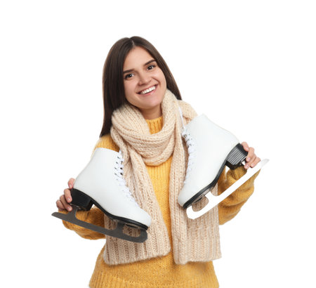 Happy woman with ice skates on white backgroundの写真素材