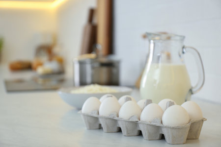 Fresh eggs and dairy products on countertop in modern kitchen. Space for textの写真素材