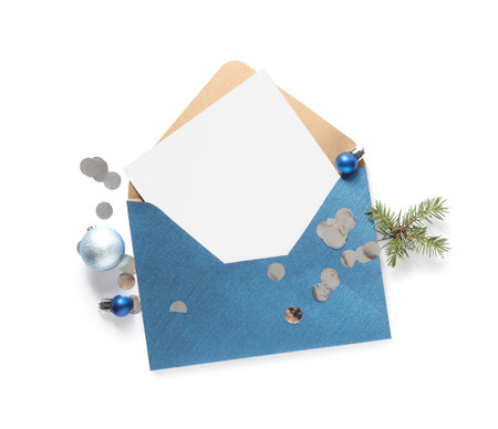 Blank greeting card in envelope and Christmas decor on white background, top view. Space for textの写真素材