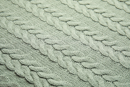Soft knitted plaid as background, closeup view