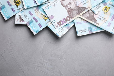 Ukrainian money on grey background, flat lay. Space for textの写真素材