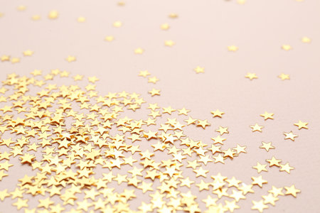 Confetti stars on pink background. Christmas celebration