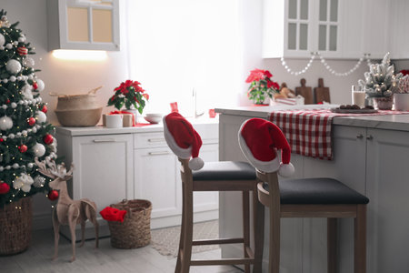 Beautiful kitchen interior with Christmas tree and festive decorの写真素材