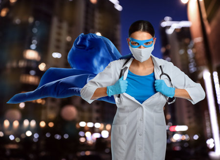 Doctor dressed as superhero on night city background. Medical workers fighting dangerous diseasesの写真素材
