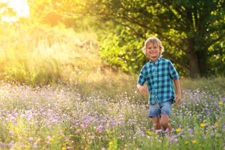 Cute little boy outdoors, space for text. child spending time in natureの写真素材