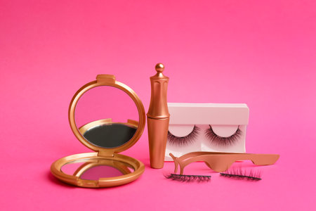 Magnetic eyelashes and accessories on crimson backgroundの写真素材