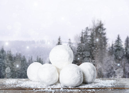 Snowballs against blurred coniferous forest. Winter outdoor activitiesの写真素材