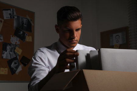 Professional detective doing paperwork in his office
