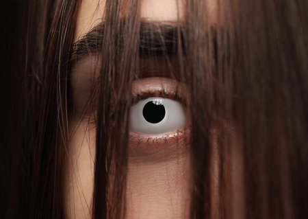 Mysterious witch with spooky eyes, closeup. halloween partyの写真素材