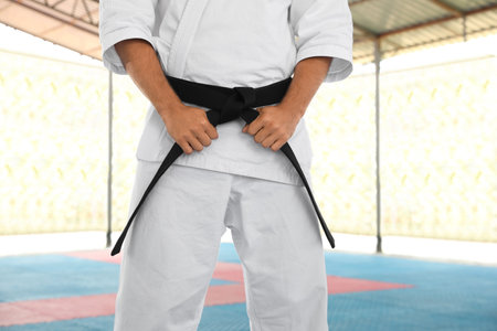 Karate coach wearing kimono and black belt at outdoor gym, closeupの写真素材